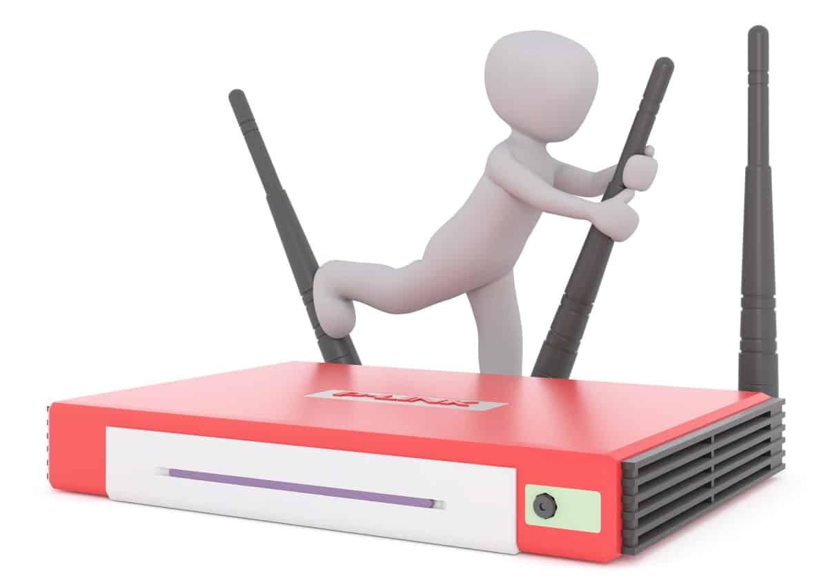 a miniature humanoid figure manually adjusting the router antennas